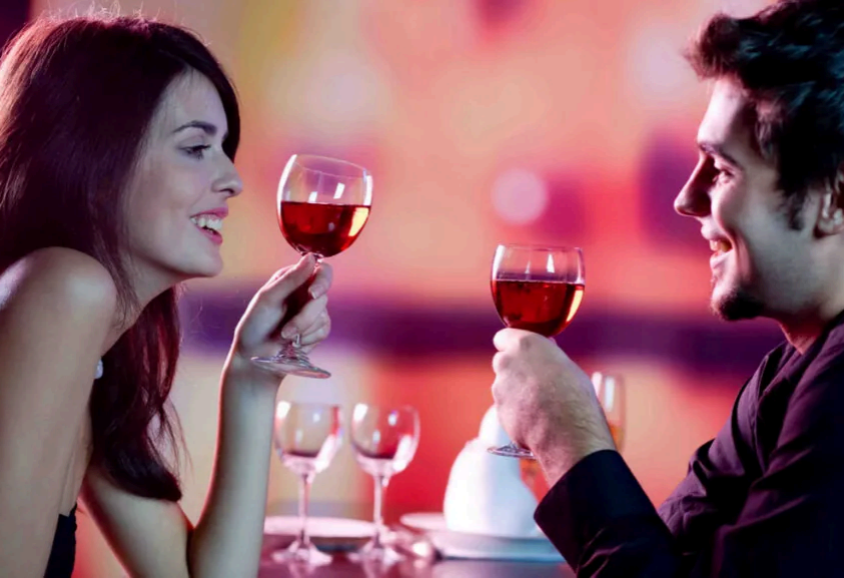 couple sitting at table with wine glasses, fundraising ideas, charity ideas, silent auction items, travel fundraising events