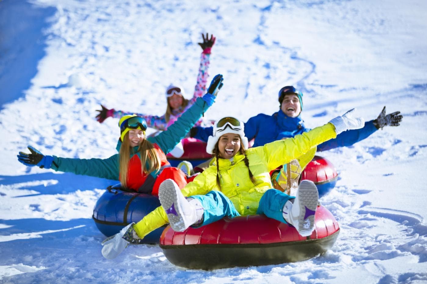 Family sliding down mountain in tubes, fundraising ideas, charity ideas, silent auction items, travel fundraising events