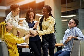 adults in group touching hands, fundraising ideas, charity ideas, silent auction items, travel fundraising events