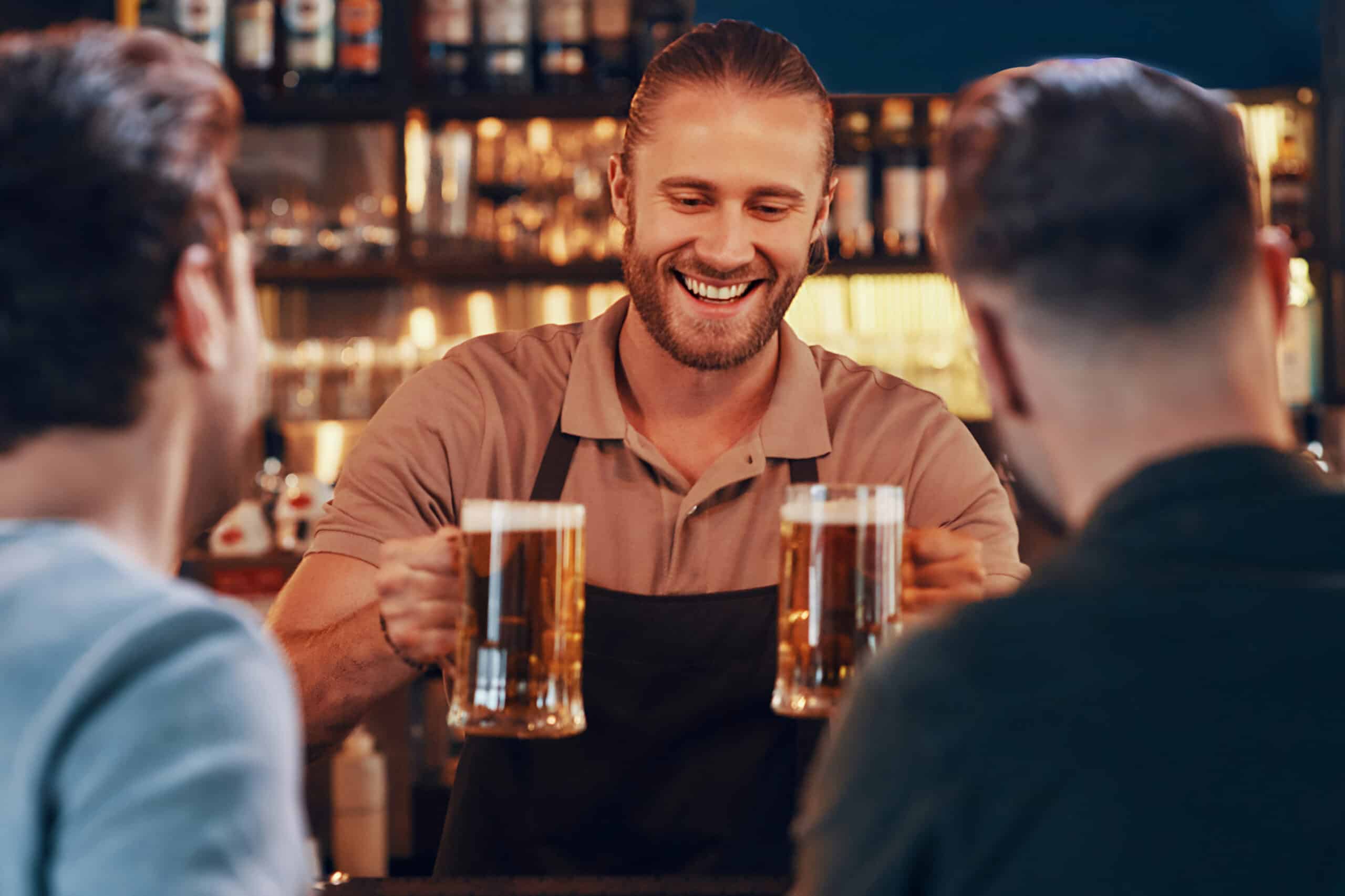 man holding to glasses of beer, charity auction travel packages, vacation fundraising, travel fundraising, fundraising ideas, charity ideas, silent auction items, travel fundraising events