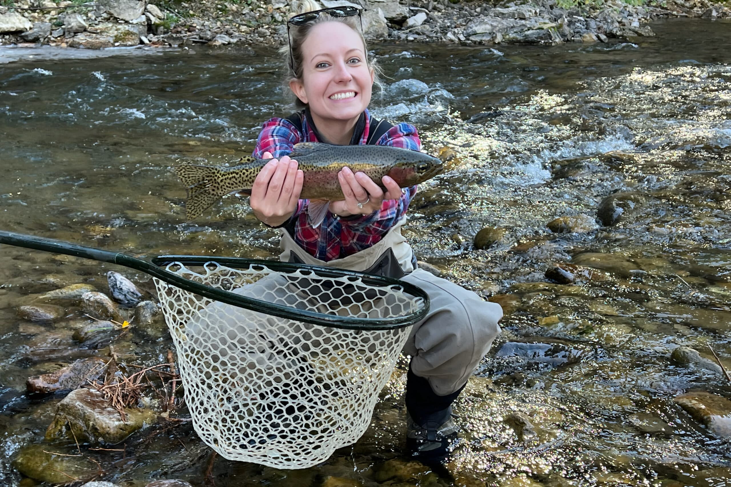 woman holding trout, charity auction travel packages, vacation fundraising, travel fundraising, fundraising ideas, charity ideas, silent auction items, travel fundraising events